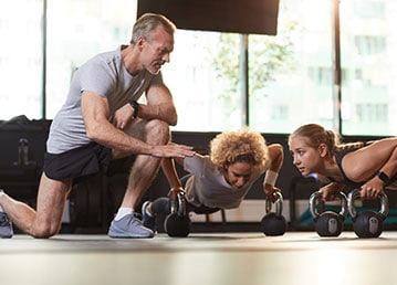 Image4 Instructor giving advices to her clients while exercising.
