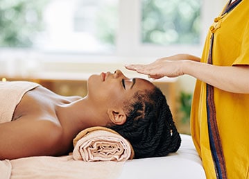 Image5 Woman relaxing while enjoying her Reiki therapy.